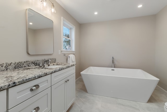 bathroom featuring vanity and a tub to relax in