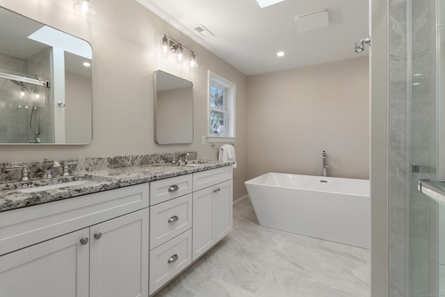 bathroom featuring vanity and independent shower and bath