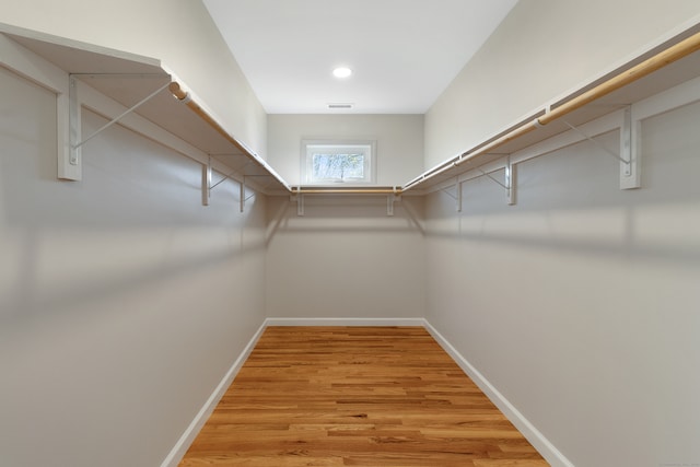 spacious closet with light hardwood / wood-style floors