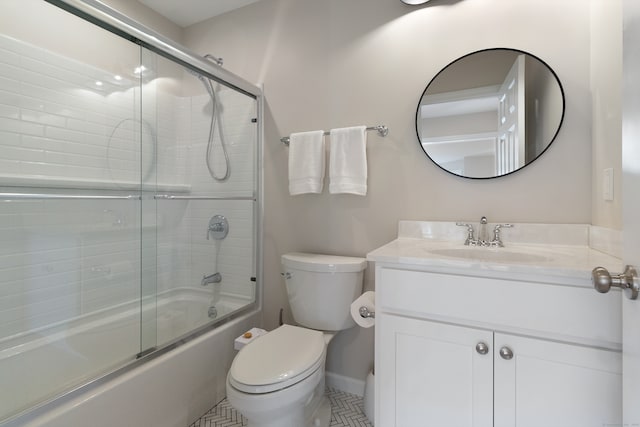 full bathroom featuring tile patterned floors, vanity, toilet, and enclosed tub / shower combo