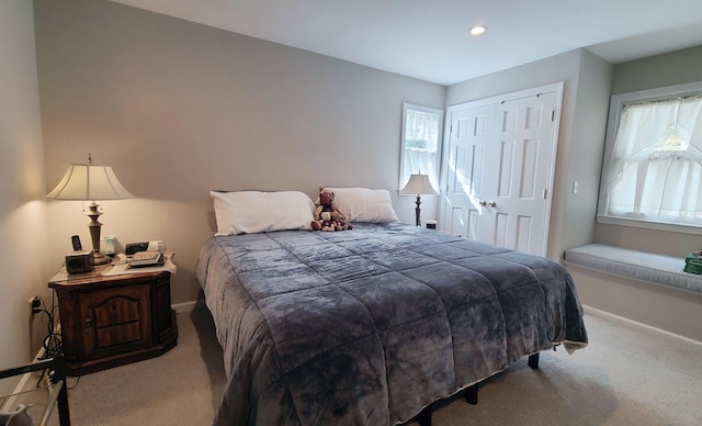 carpeted bedroom with a closet