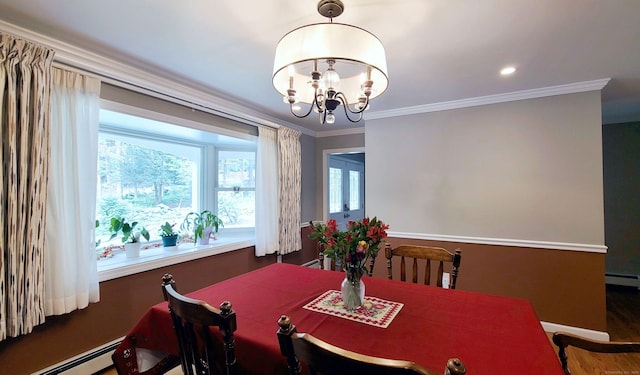 dining room with crown molding, a baseboard radiator, and a chandelier