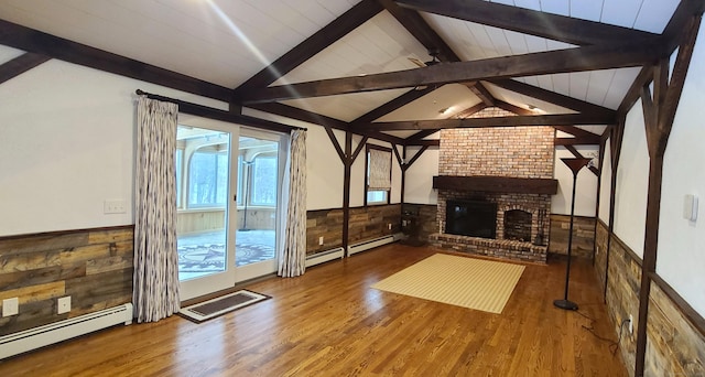 unfurnished living room featuring a baseboard radiator, hardwood / wood-style floors, a brick fireplace, and vaulted ceiling with beams