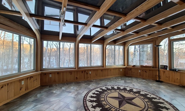 unfurnished sunroom with beam ceiling and ceiling fan