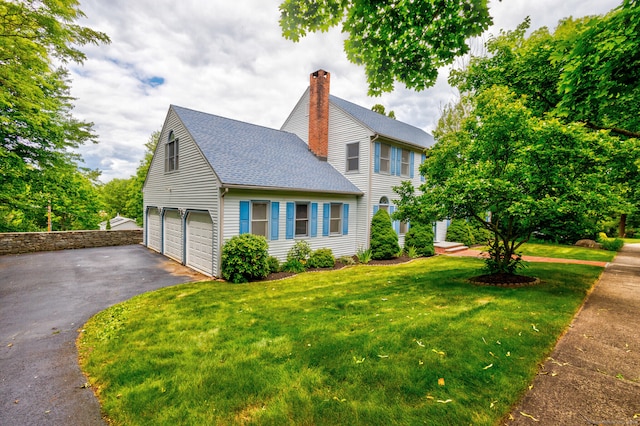 exterior space with a garage and a front lawn