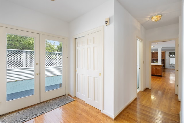 doorway to outside featuring light hardwood / wood-style floors and french doors