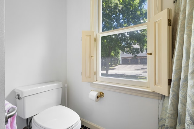 bathroom featuring toilet and plenty of natural light