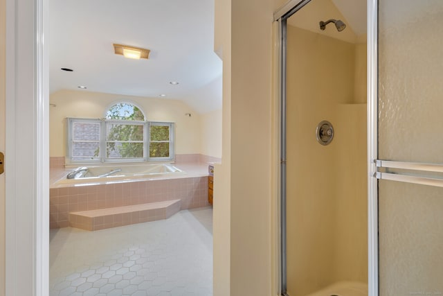 bathroom featuring tile patterned floors, lofted ceiling, and separate shower and tub