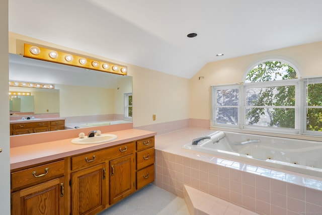 bathroom featuring vanity, tiled bath, tile patterned floors, and lofted ceiling