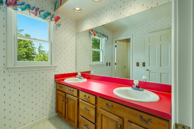 bathroom featuring a wealth of natural light, vanity, and tile patterned floors