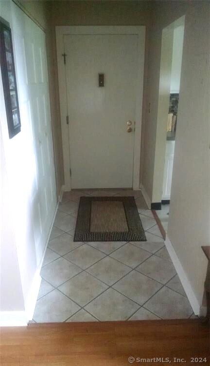 corridor with light tile patterned floors