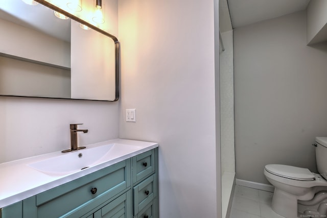 bathroom with vanity, a shower, toilet, and tile patterned flooring