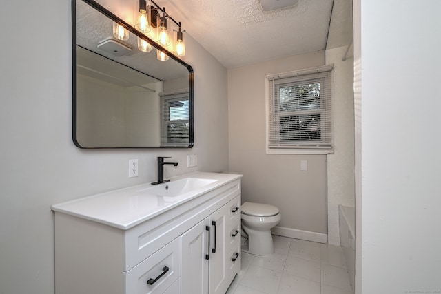 bathroom with vanity, toilet, a tub to relax in, and a textured ceiling