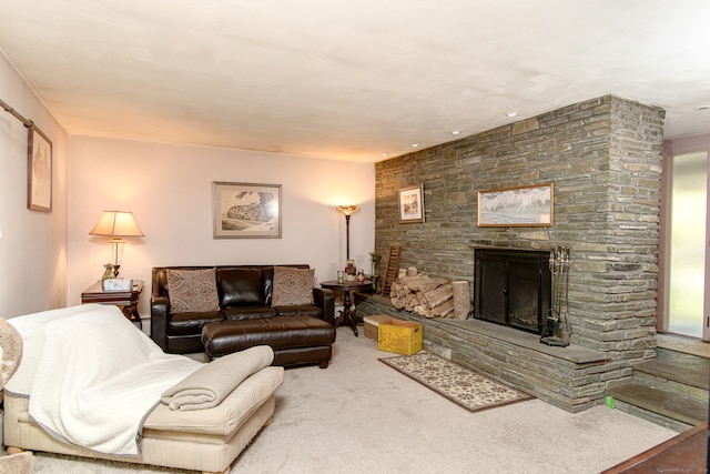 carpeted living room with a stone fireplace