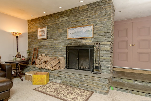 living room with carpet and a fireplace