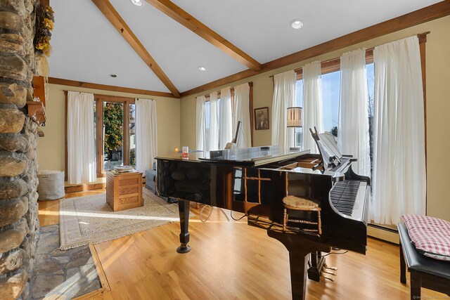 misc room featuring vaulted ceiling with beams, a baseboard radiator, and light hardwood / wood-style floors