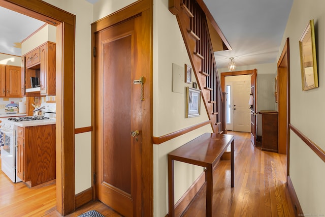 hallway with light hardwood / wood-style floors