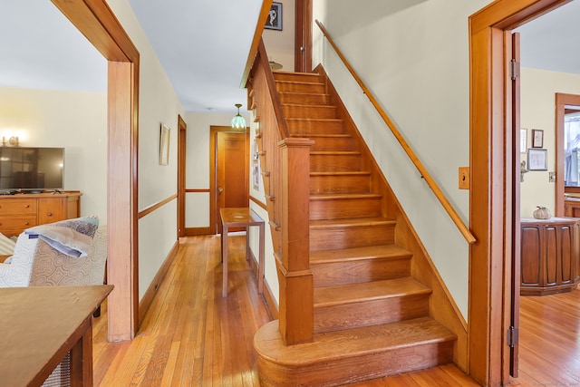 staircase with hardwood / wood-style floors