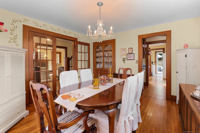 dining room featuring light hardwood / wood-style floors and a notable chandelier