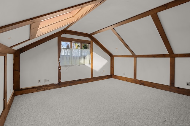 bonus room with lofted ceiling with skylight and carpet floors