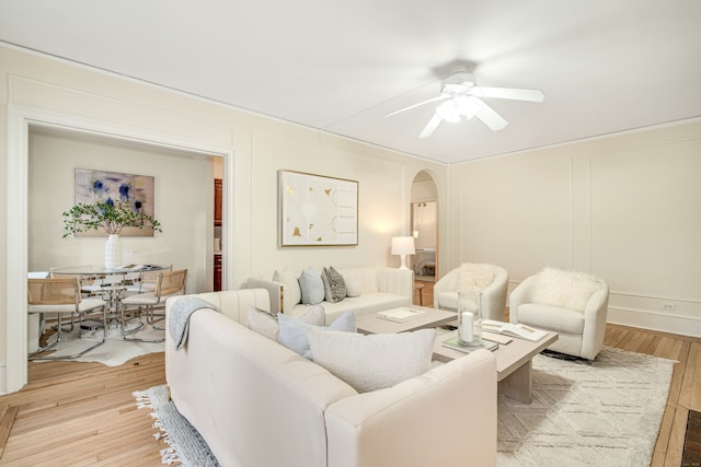 living room featuring ceiling fan and light wood-type flooring