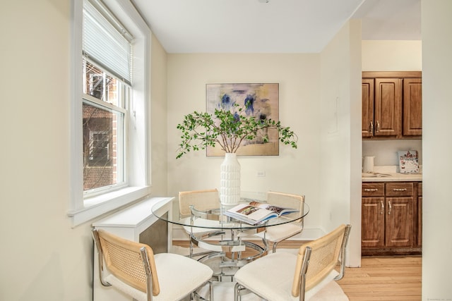 dining space featuring a healthy amount of sunlight and light wood-type flooring