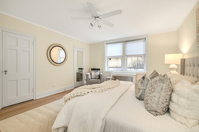 bedroom with ornamental molding, ceiling fan, and light wood-type flooring