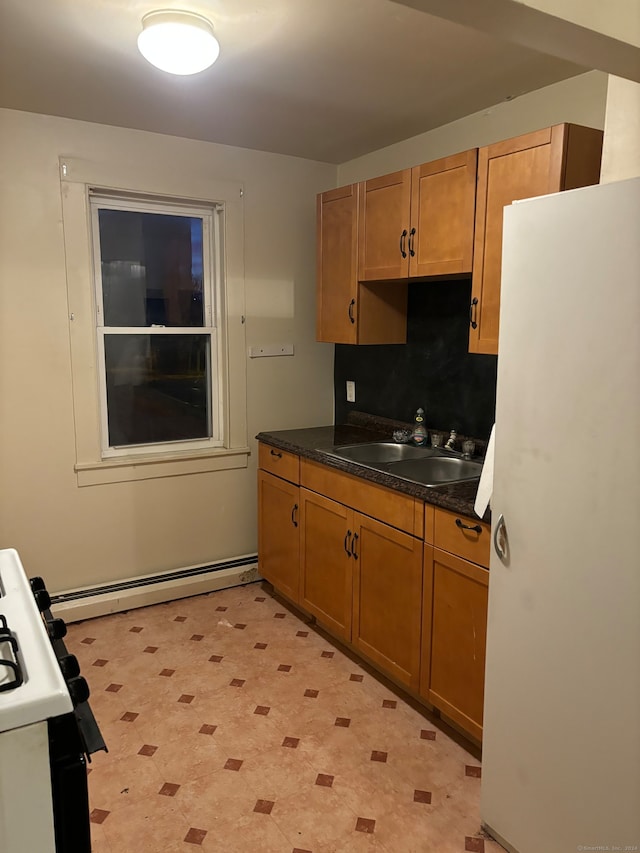 kitchen with white appliances, sink, and baseboard heating