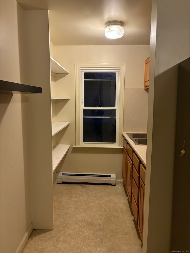 interior space with baseboard heating and sink