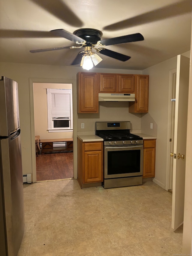 kitchen with baseboard heating, appliances with stainless steel finishes, light wood-type flooring, and ceiling fan