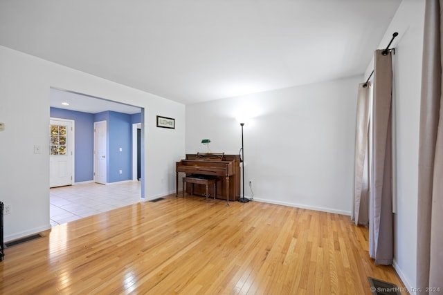 spare room with light hardwood / wood-style flooring