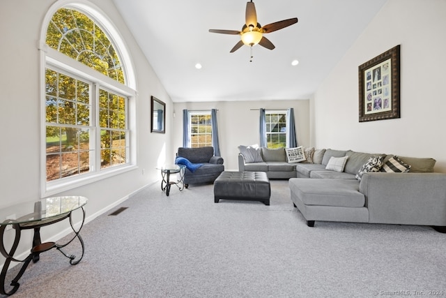 carpeted living room with ceiling fan and lofted ceiling