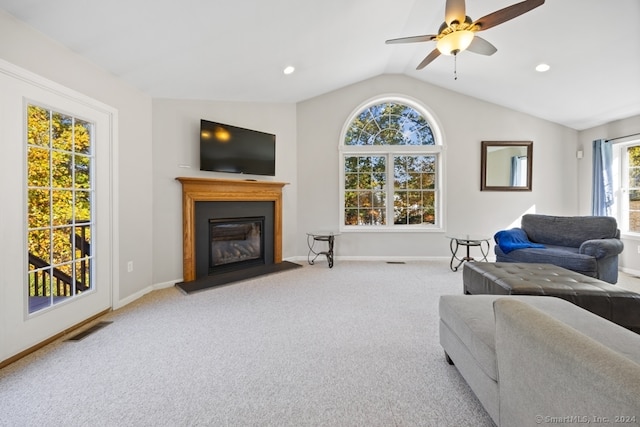 carpeted living room featuring vaulted ceiling, a wealth of natural light, and ceiling fan