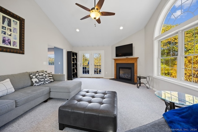 carpeted living room featuring high vaulted ceiling and ceiling fan