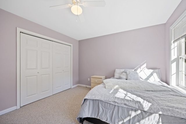 bedroom with carpet flooring, ceiling fan, and a closet