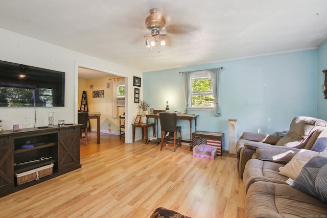 living room with light wood-type flooring and ceiling fan