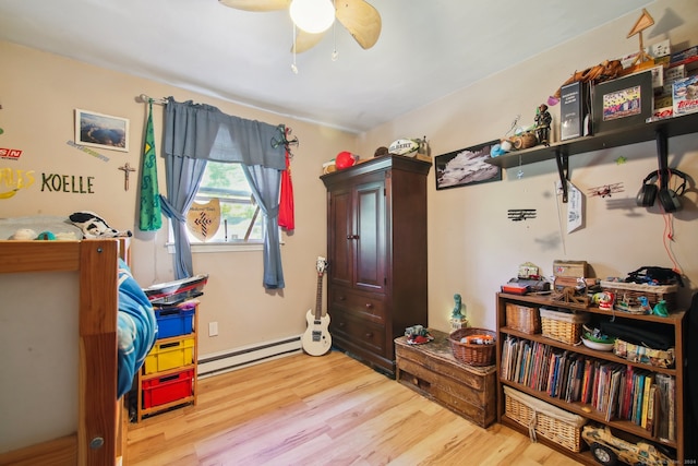 interior space with light hardwood / wood-style floors, a baseboard heating unit, and ceiling fan