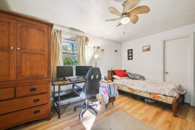 bedroom with light hardwood / wood-style floors and ceiling fan