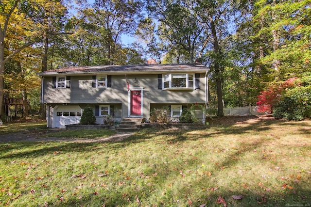 bi-level home featuring a front yard and a garage