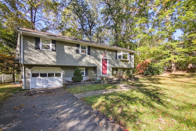 bi-level home with a front yard and a garage