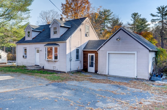 new england style home featuring a garage and cooling unit