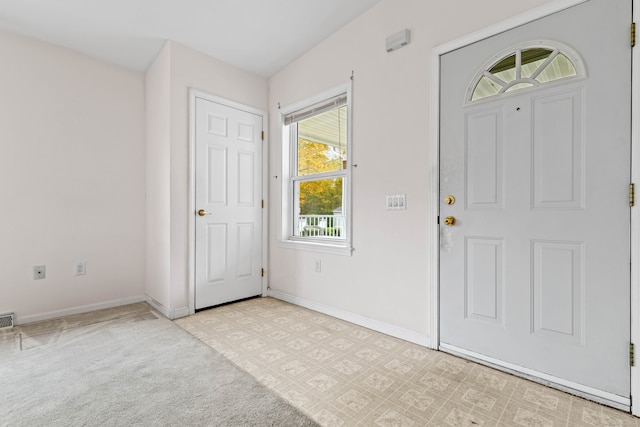 entrance foyer with light colored carpet