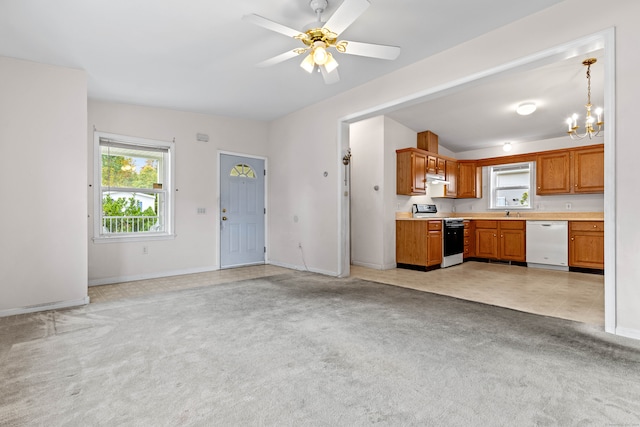 unfurnished living room featuring light carpet and ceiling fan with notable chandelier