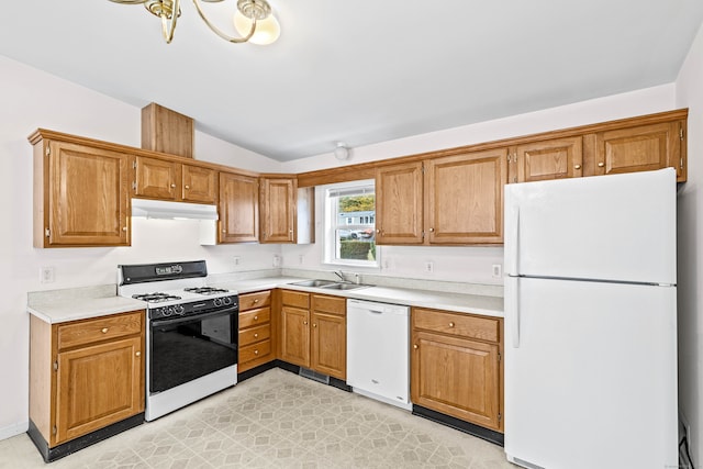 kitchen featuring lofted ceiling, sink, and white appliances