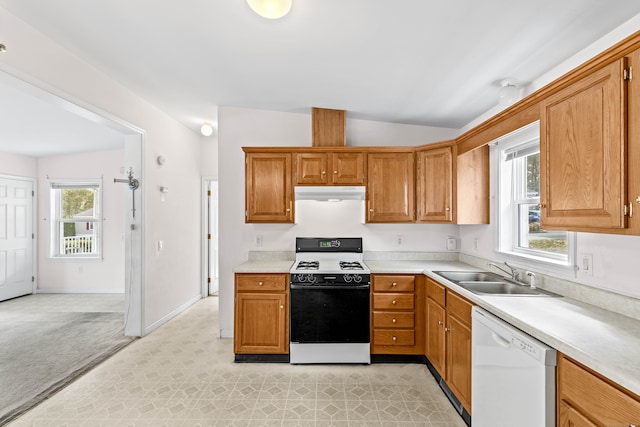 kitchen with lofted ceiling, a healthy amount of sunlight, white dishwasher, sink, and range