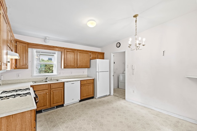 kitchen with washer / dryer, a chandelier, sink, decorative light fixtures, and white appliances