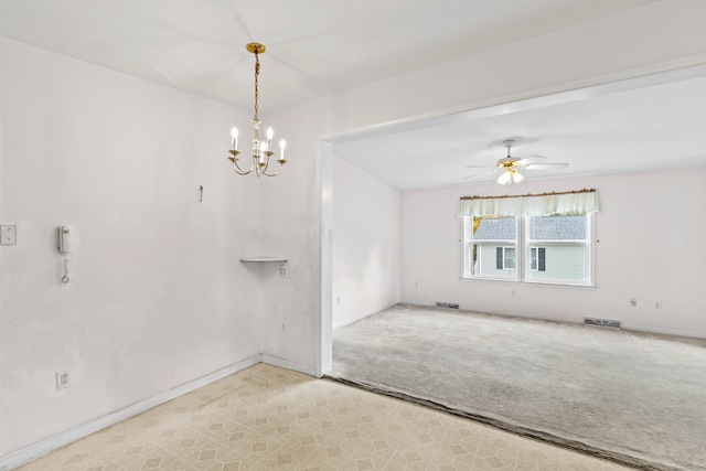 empty room featuring light carpet and ceiling fan with notable chandelier