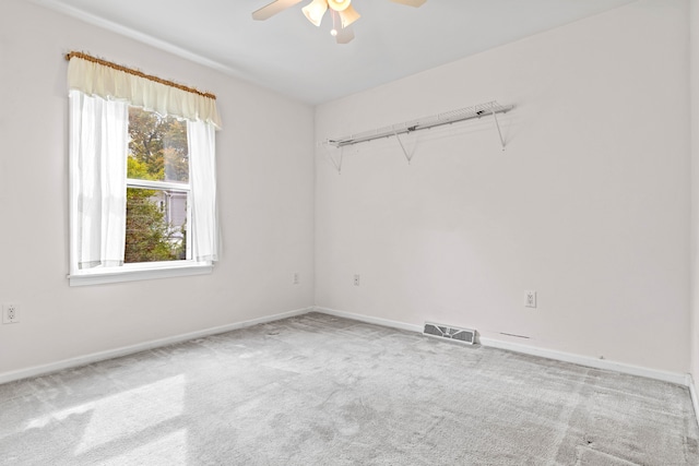 carpeted empty room featuring ceiling fan