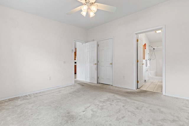 unfurnished bedroom with light carpet, connected bathroom, and ceiling fan