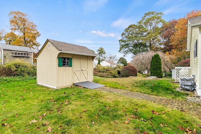 view of outbuilding featuring a yard